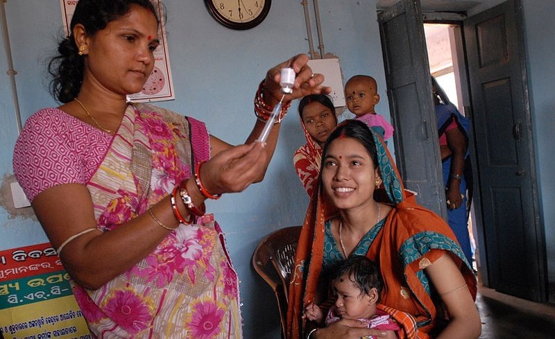 A community health worker gives a vaccination in Odisha