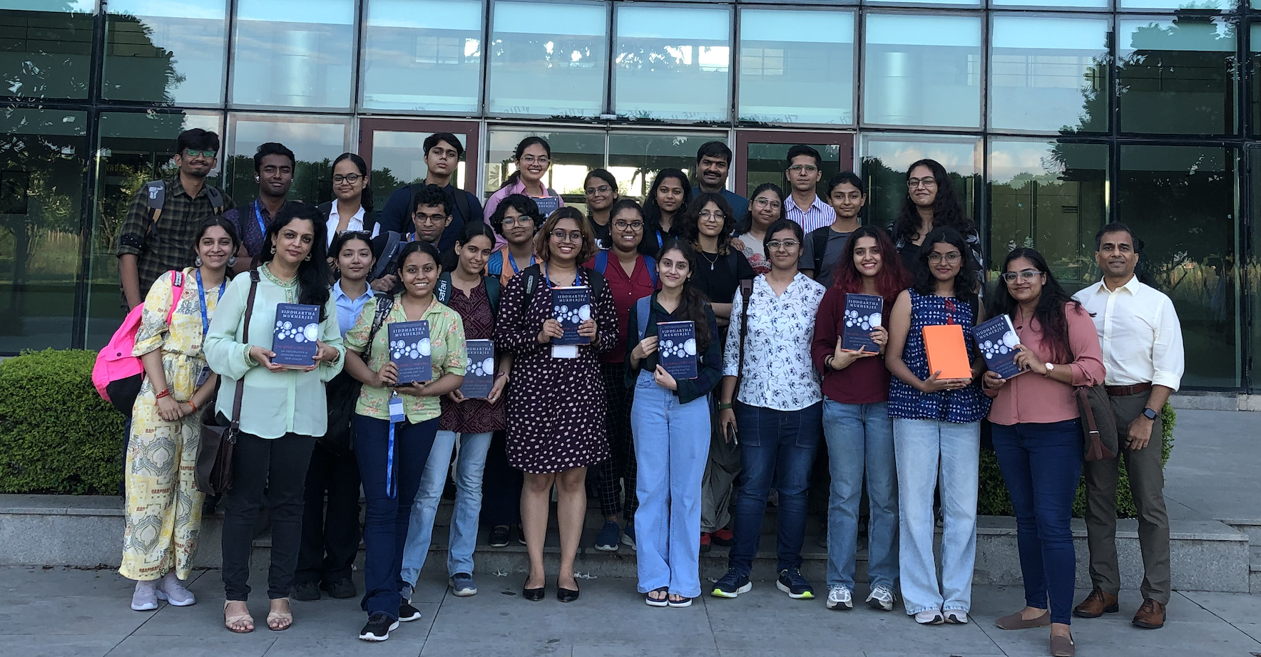Participants posing with Siddharth Mukherjee's book, 'The song of the cell'.